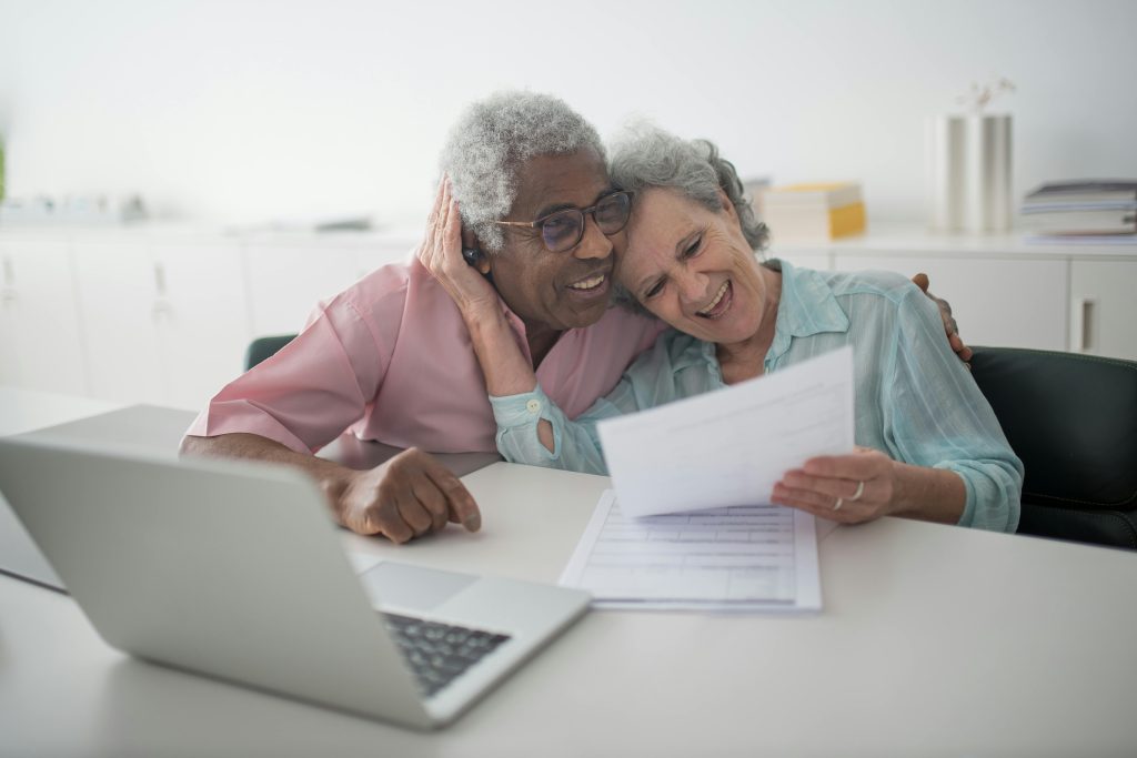 | dickey insurance solutions a Happy Elderly Couple Holding a Document.