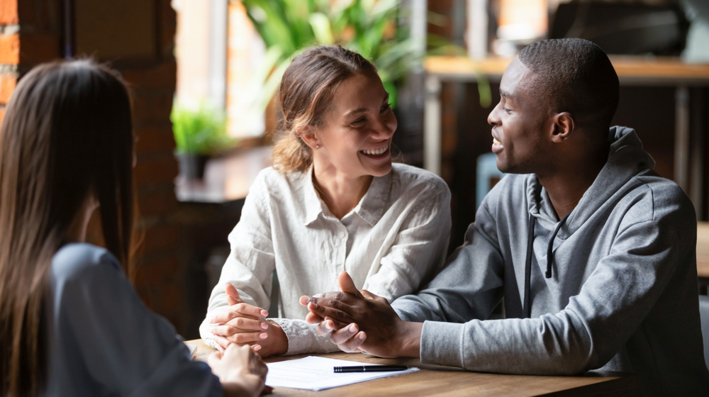 Young couple discussing homeowners insurance and financial decisions